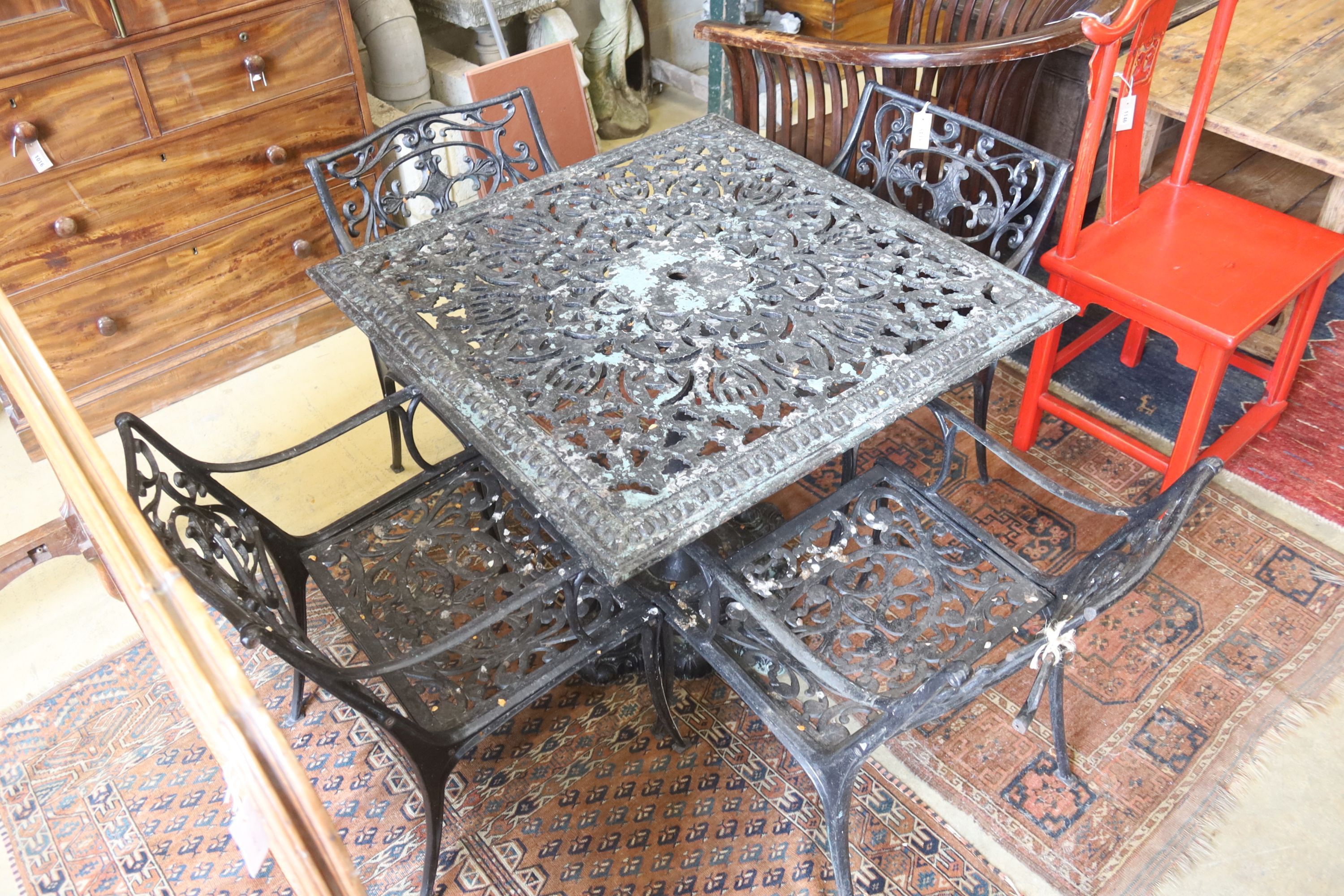 A Victorian style square cast metal garden table, width 88cm, height 72cm and four elbow chairs (one a.f.)